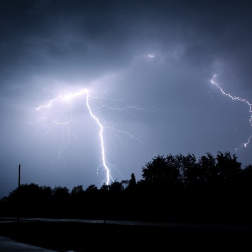 Lightning in a dark sky. Photo by Ryan on Unsplash.